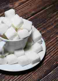 Sugar Cubes In A Tea Cup On Wooden Table