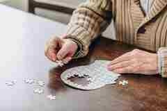 Elderly person with a jigsaw. 