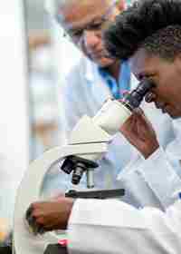 Medical Researcher Using Microscope