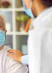 Elderly Patient And Healthcare Professional Wearing Masks